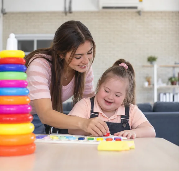 Therapist supporting a child with developmental needs.